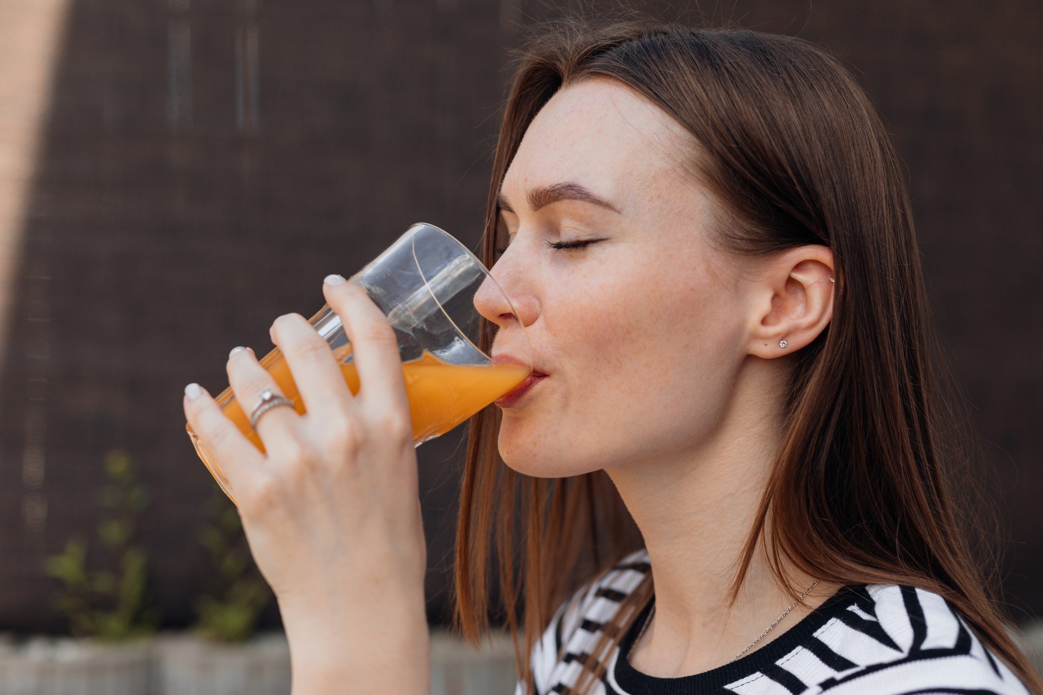 Portrait of young woman drinking