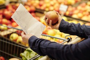 Person Looking at Grocery List in Store